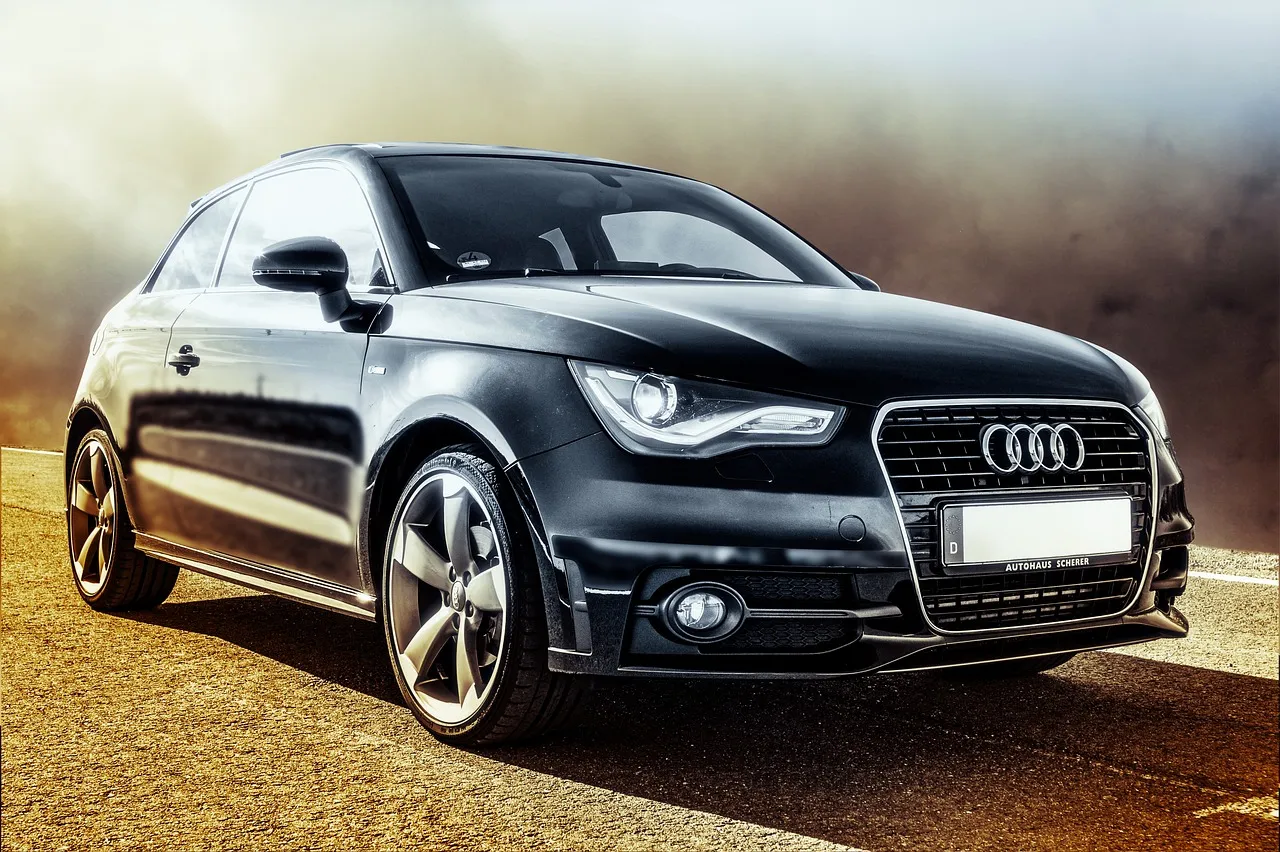 Black sedan driving on a dusty country road