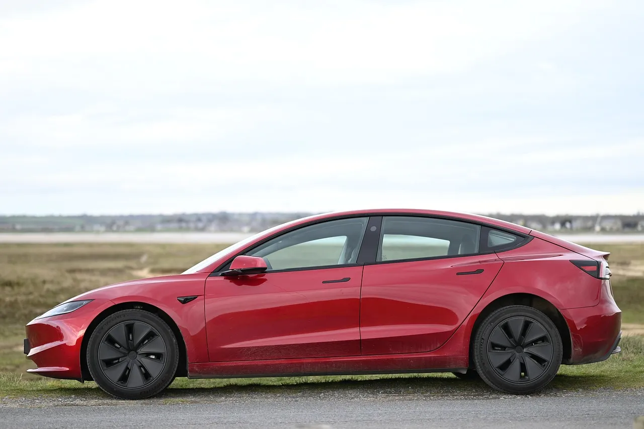 Red electric sedan parked outdoors