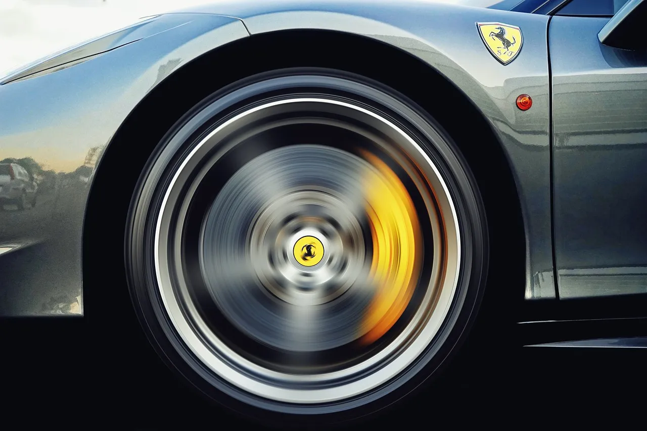 Close-up of an alloy wheel and brake caliper in motion